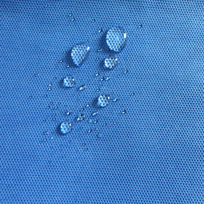 Water droplets sitting on blue leak-proof SMS non-woven fabric